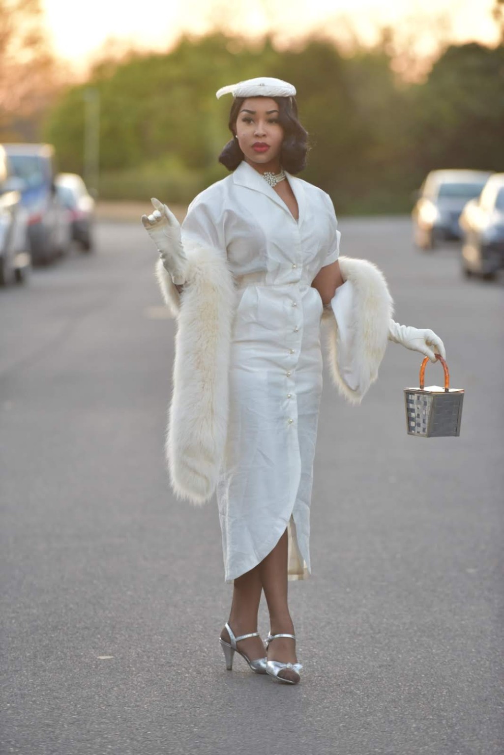 Lady E in a white dress with matching hat and gloves
